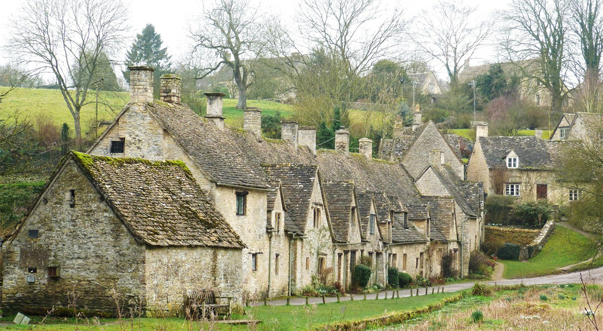 home-page-image1 Row of historic stone cottages in Arlington Row, Bibury, one of the most photographed and iconic locations in the Cotswolds