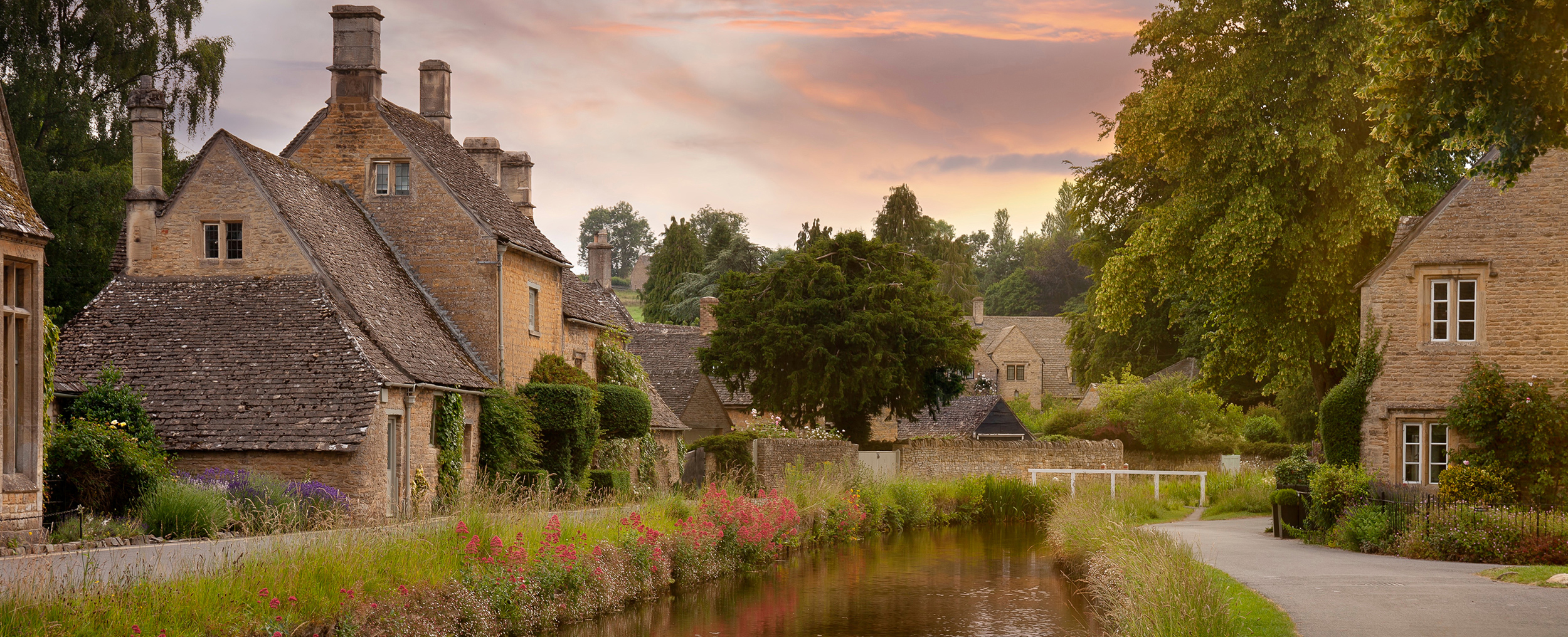 Traditional honey-stone cottages beside the River Windrush at Bourton-on-the-Water, one of the most iconic villages in the Cotswolds