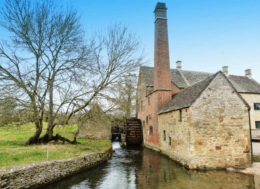 Lower Slaughter Old Mill with waterwheel beside the River Eye, a historic and picturesque landmark in the Cotswolds